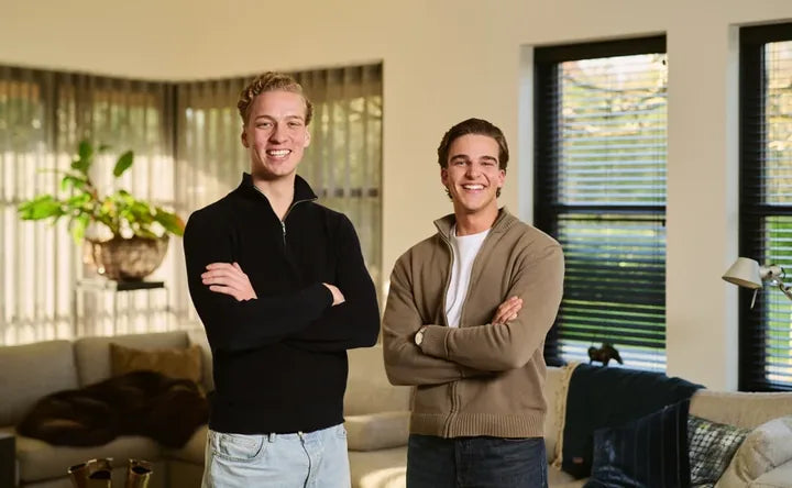 The two FINEX founders standing in a living room
